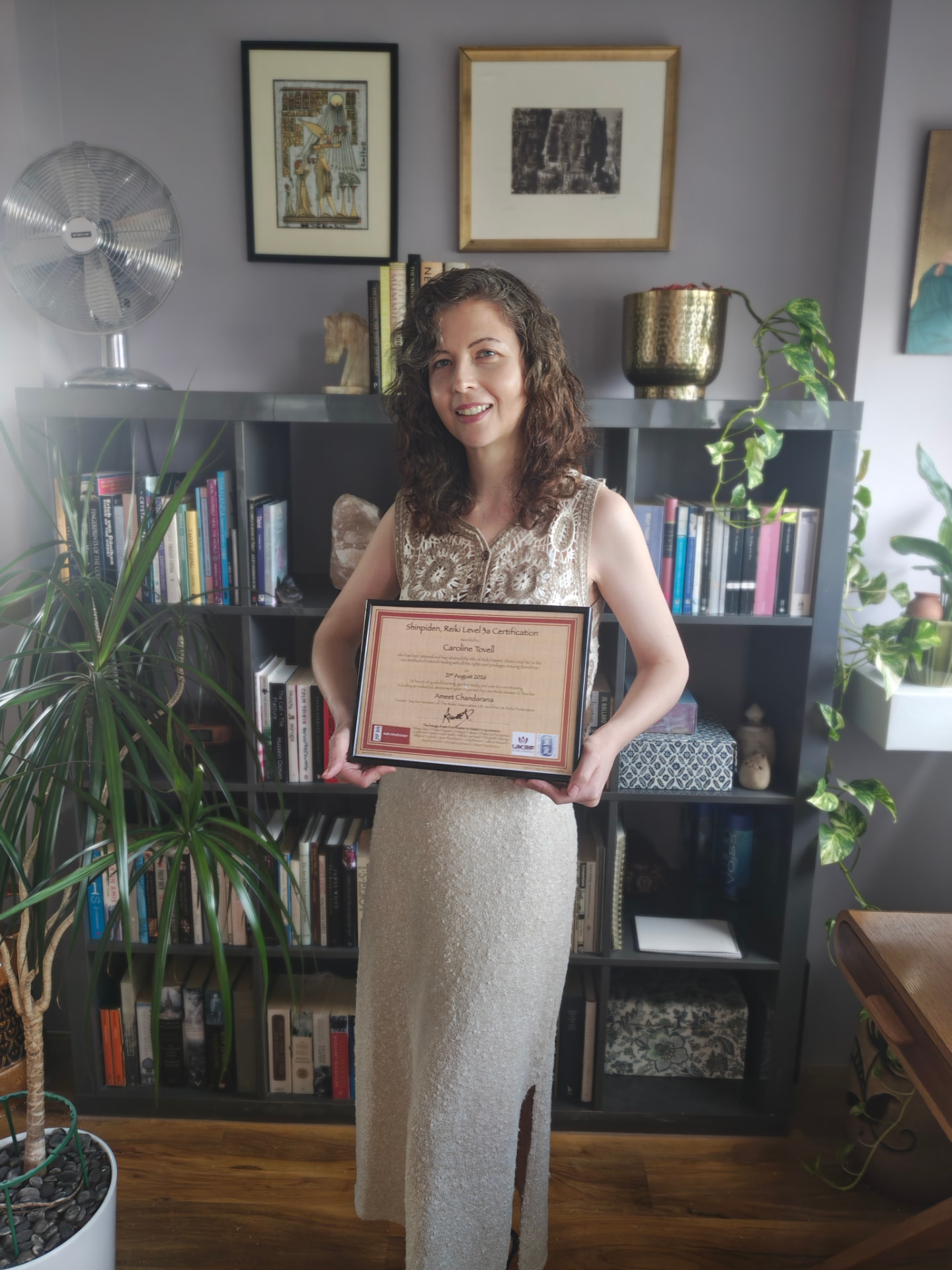 Caroline Tovell, Usui Reiki Master at Owl Reiki in Enfield Town, holding her Reiki certification